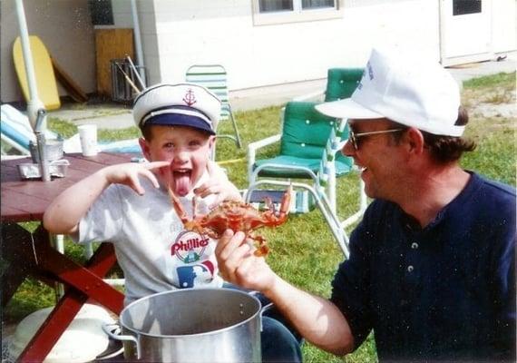 Lil' brother & Pa Dukes eating crabs they caught off the bridge into town, c. 1990