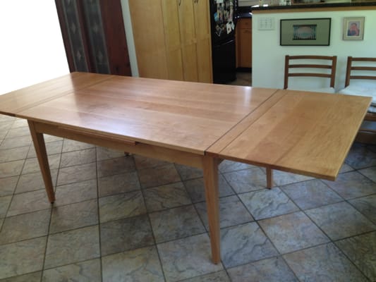 Stow Leaf Table with both leaves extended.  Leaves are stored beneath the table top and extend from the ends of the table.