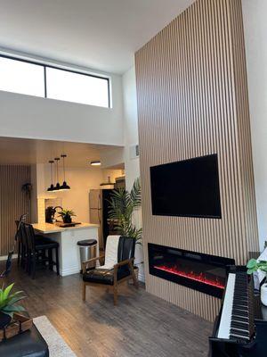 Living Room Fireplace Covered in Acoustic Wood Veneer Wall Panels