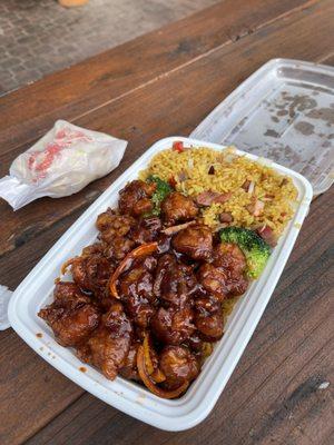 Orange chicken that comes with pork fried rice and a huge crispy egg roll