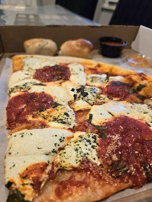 Two margherita slices and garlic knots.