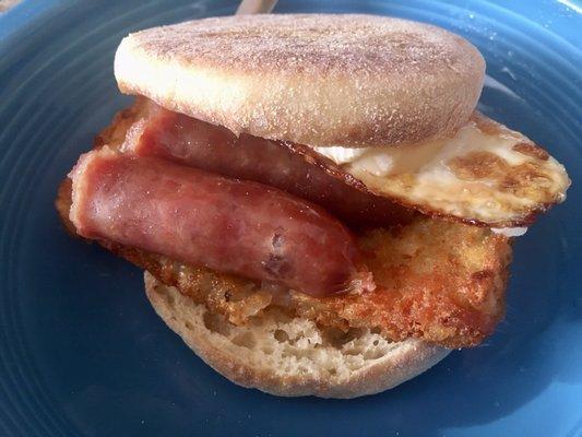 English Muffin w/ Brie Cheese, Fried Egg, Kam Yen Jan Chinese Style Sausage, Hash Brown Patty & Curry Ketchup