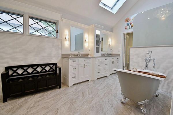 Custom bathroom design with full remodel. Claw foot bathtub with his and her sinks.