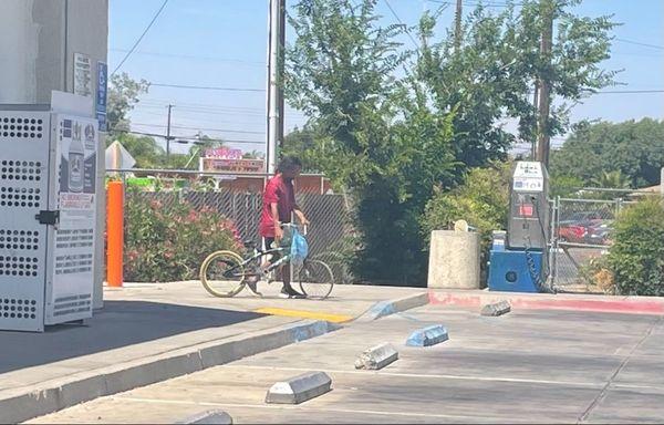 He's about to mess with the water/air machine. His buddy is around the corner there, relaxing on a milk crate and slamming a tall boy.