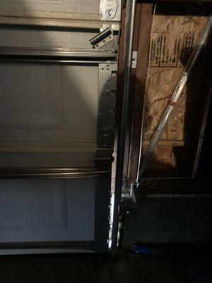 Three broken rollers, bent bars, bent door showing gap to outside.