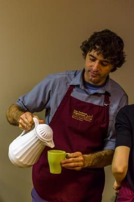 Pouring milk into a cup of coffee