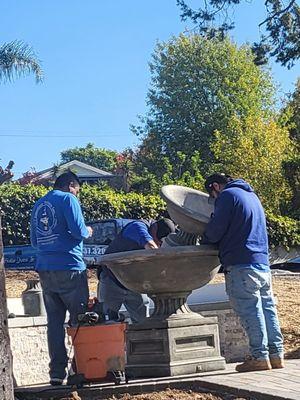 Balancing and caulking the water fountain.