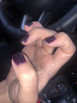 Trying to show my sisters poorly painted dark purple gel manicure.