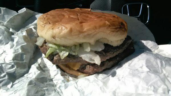 Double cheeseburger with onion, tomato, lettuce.