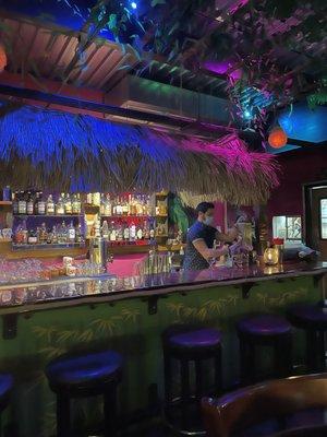 Exotic lighting and thatched roofs at the bar.