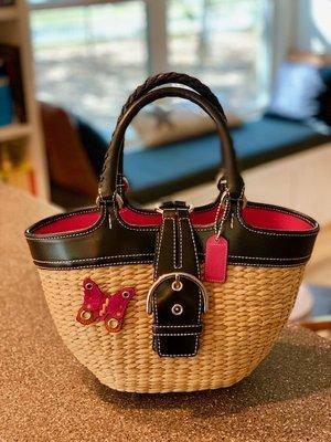 Another Coach Bag going to a new home. Summer straw with black trim, leather butterfly and pink lining. Darn you Marie Kondo!