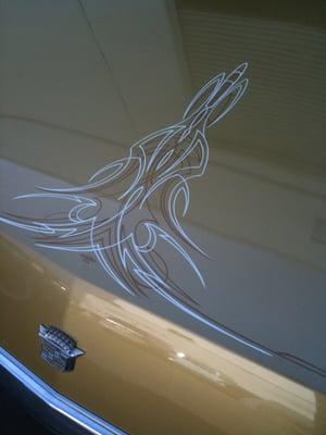 beautiful pinstripe design done with pinstriping brush on a cadillac hood