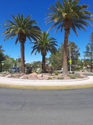 A traffic circle populated with sculpture deer.