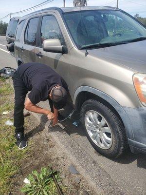 Oscar changing out tire