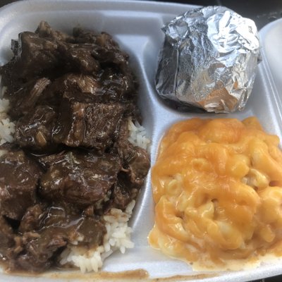 Beef tips with rice, Mac and cheese, and a cornbread muffin