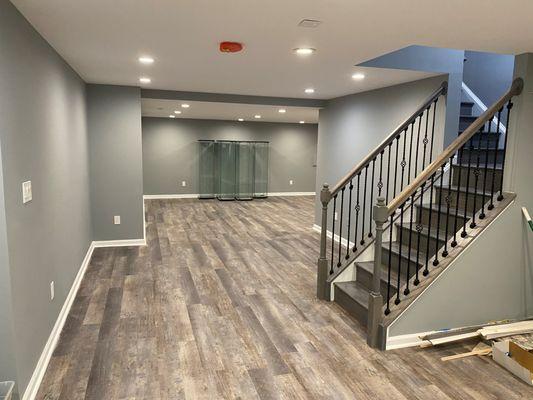 Basement finish with new LVP flooring , new staircase , new ceiling lights and new paint.