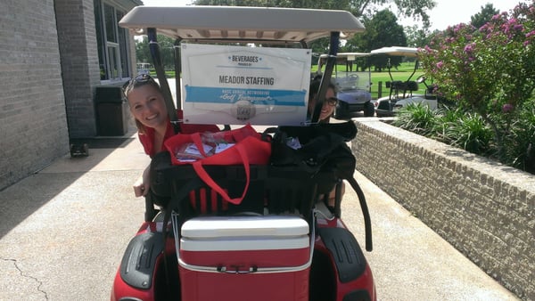 Staffing Consultants Shirley and Trish manning the golf cart for Meador at a community golf tournament