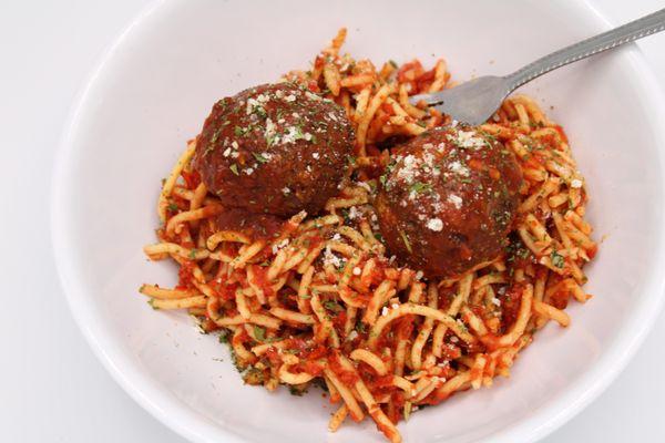 Spaghetti and meatballs topped with parmesan and parsley