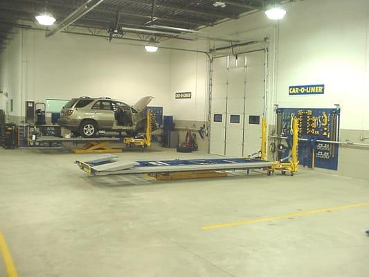 Bright and Clean Collision Shop, multiple Frame Racks & hoists.