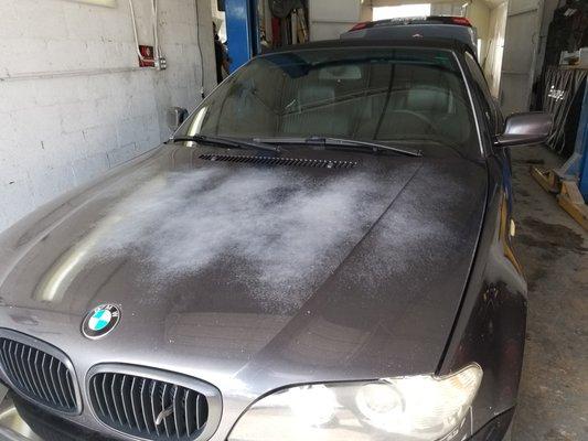 A sunburned BMW in for new paint.