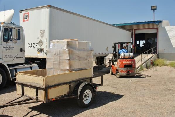 Loading pallets in my trailer for the last five miles of their journey.