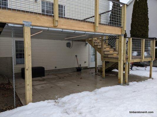 Lower poured-concrete patio which is dried-in with a roof, HUGE upper deck wraps around to a front porch. Lighting all around.