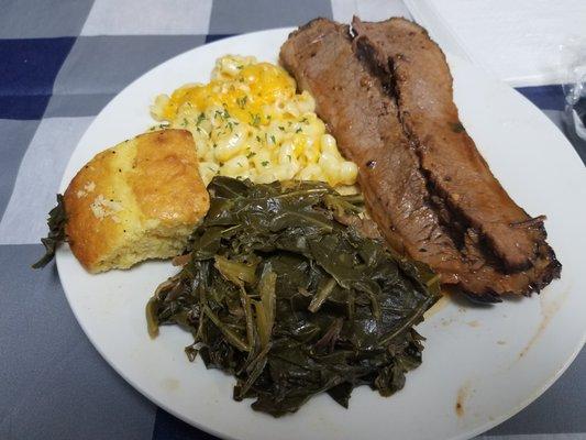 Brisket with mac and cheese, cornbread, and collard greens