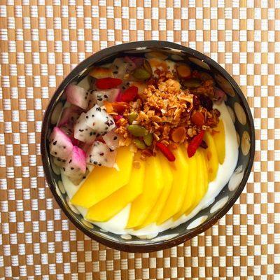 Yogurt with Super Goji Berry Granola, slices of mango and cubes of dragonfruit.