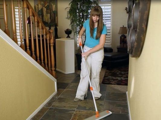 Mopping the floor using our environmentally friendly cleaner and sanitized mop system.