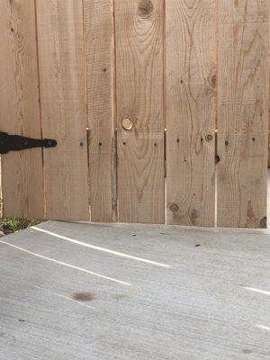 Gate to dog run does not open all the way because door hits concrete at the back of the gate.