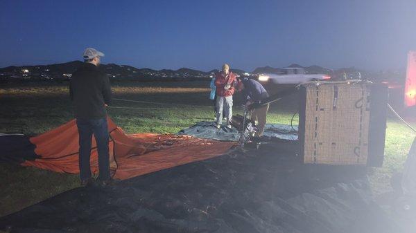 Gathering the deflated balloon after landing.