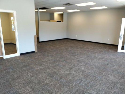 New petition walls, carpet tile installation, rubber base board, new door frame, trim and replacing of drop ceiling tiles.