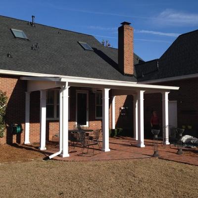 The new patio addition is enhanced with the 8" matching aluminum columns supporting the shingled insulated roof system.