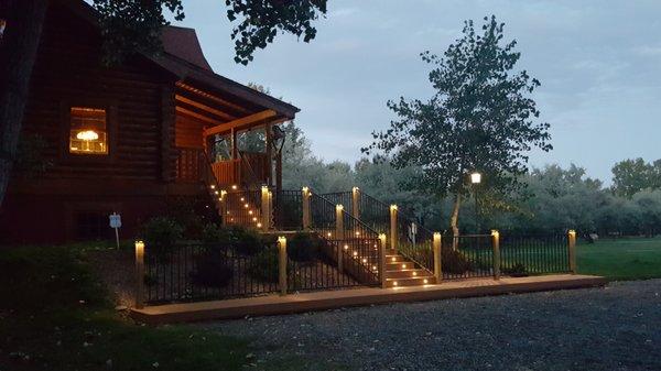 Stairs and landing. Composite decking with pressure treated lumber. Lighting on post and stairs.