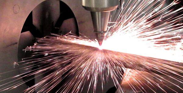 tube laser cutter cutting through metal