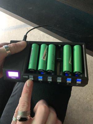 Three batteries on the left from vape shop, only one taking a charge