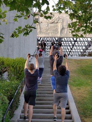 Bootcampers lifting weights while going up the stairs!