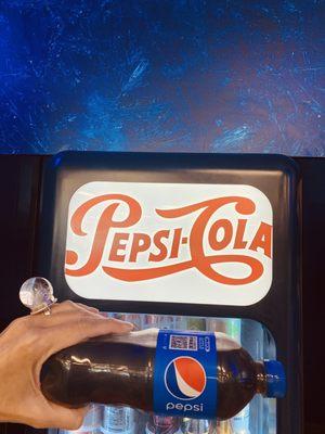 Pepsi machine inside store.