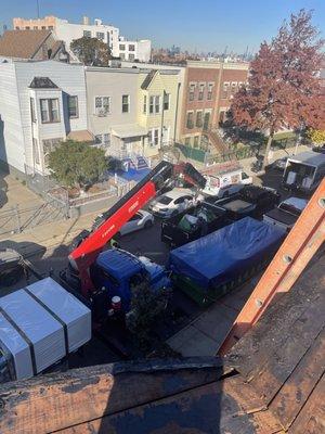 We use boom lifts to put our supplies on the roof and take the trash off the roof