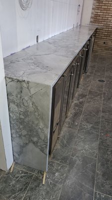 A big super white countertop with matching and mitered panel on one side. Somerville, NJ