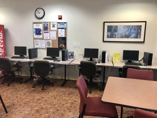 Four Lenovo computers in the student lounge.