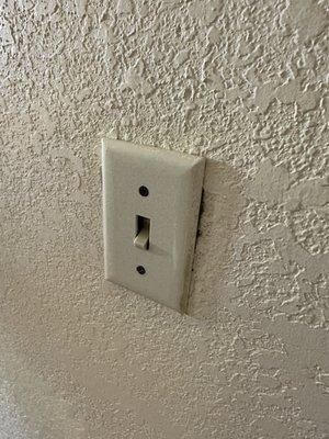 Light switch pushed into the wall, pretty sure that's a code violation