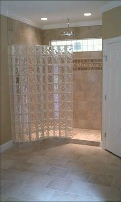 Curved glass block shower wall with ready for tile shower base