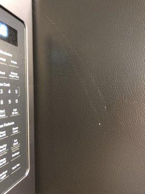 Brand new side of the fridge with scratches left from installers.  Thanks for ruining the fridge and not offering to replace it.