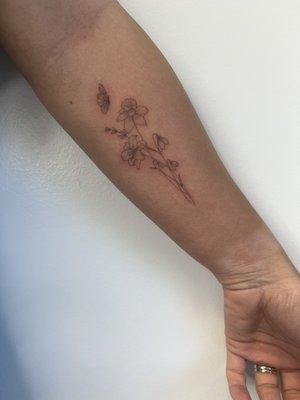 delicate floral and butterfly tattoo