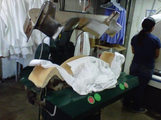 This picture shows the cuff and collars of a wet shirt being pressed.