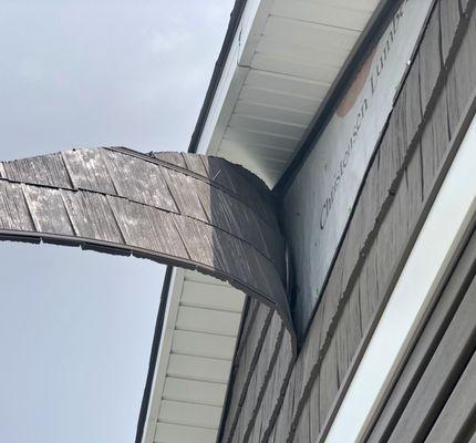 Architectural "shake siding" blew loose in relatively mild 20-25 mph winds on June 17, 2021.