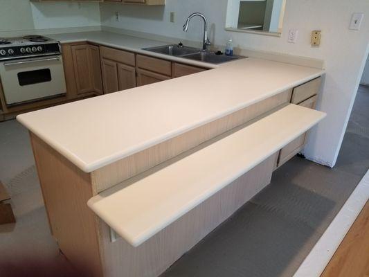 Before and after refinishing on Corian countertop.