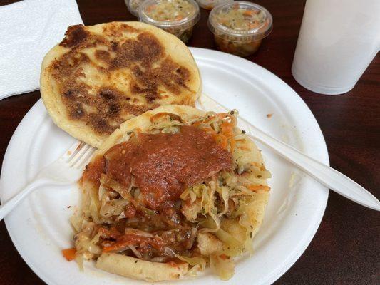 Revuelta with cabbage and tomato sauce on top.