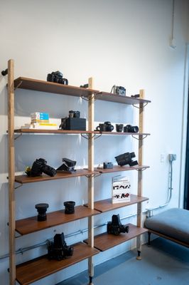 Cameras, books, and more on product shelving.